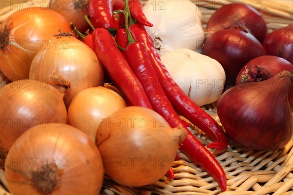 A woven basket filled with red chilli peppers