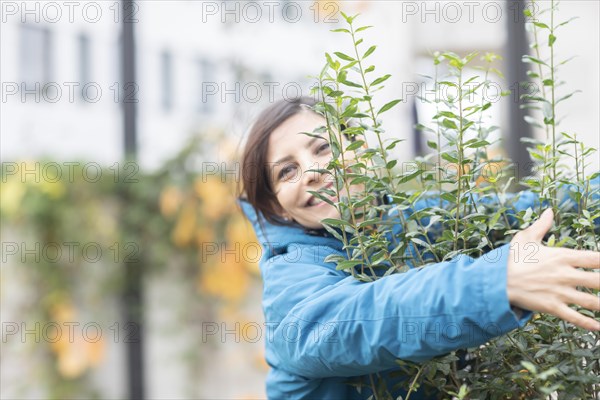 Woman hugging a bush Environmental protection