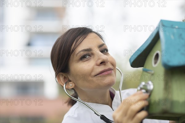 Doctor examines the condition of the nesting box with a stethoscope Environmental protection