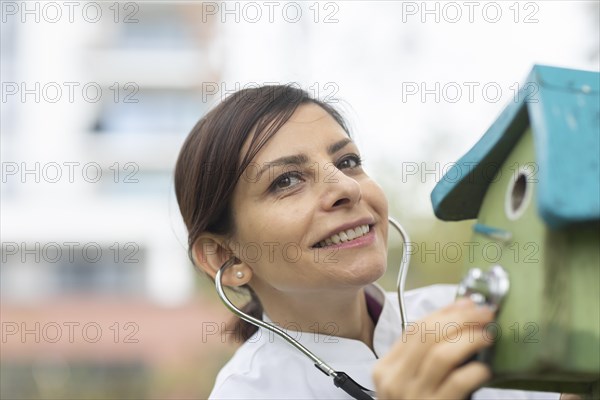 Doctor examines the condition of the nesting box with a stethoscope Environmental protection