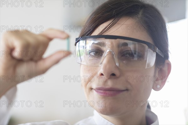 Scientist with a green part in her hand Environmental protection