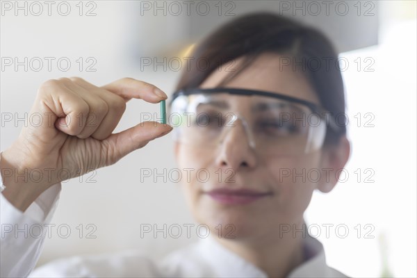 Scientist with a green part in her hand Environmental protection