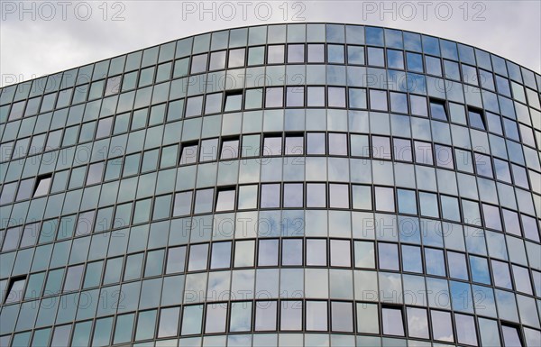 Detail of the semi-circular glass facade of an office building in the Tempelhof-Schoeneberg district