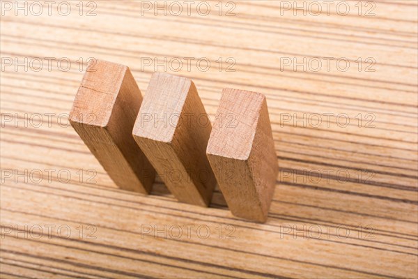 Piece of domino elements made of wood on wooden texture