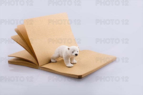 Polar bear on a notebook on a white background