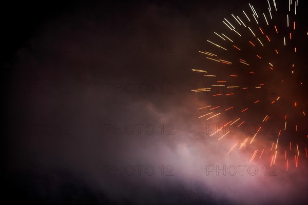 Festive colour firework background at a dark night