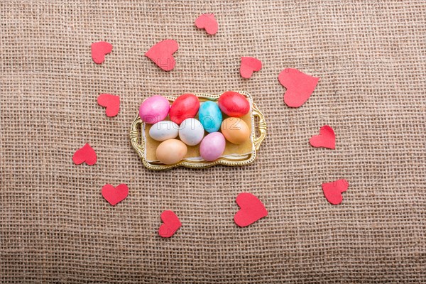 Paper heart and colorful candy sweets in tray