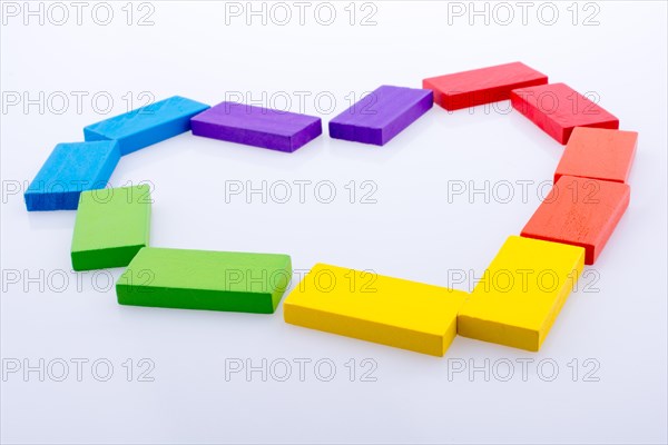 Colorful Domino Blocks forming a Heart on a white background