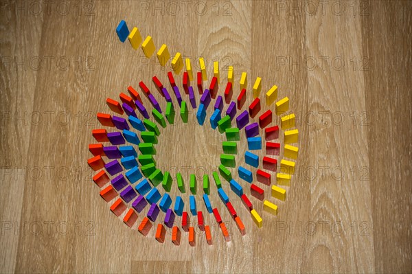 Colorful Domino Blocks in a line on a white background