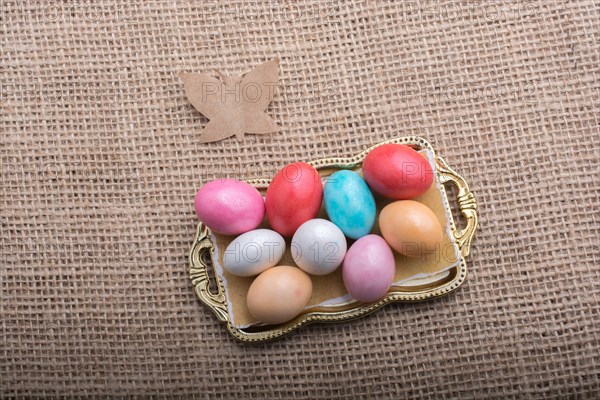 Paper Butterfly on Colorful candy sweets in tray