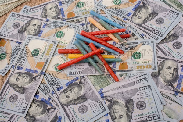 Birthday candles is placed on spread US dollar banknotes