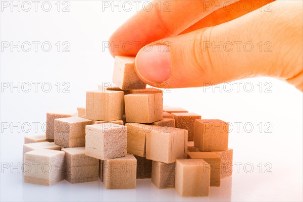 Hand playing with wooden cubes as educational and business concept