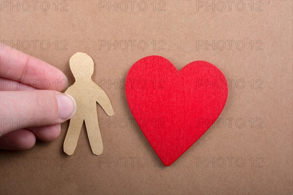 Man shape cut out of paper in hand in the view