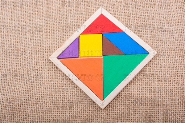 Colorful pieces of a square tangram puzzle