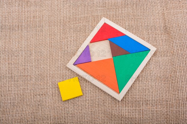 Colorful pieces of a square tangram puzzle