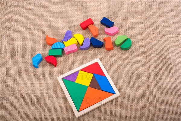 Colorful pieces of a square tangram puzzle