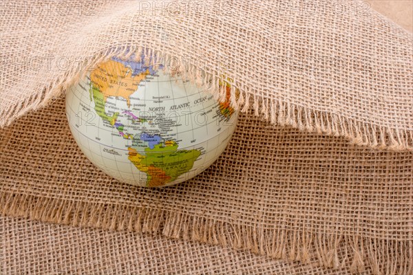 Model globe placed under a linen canvas