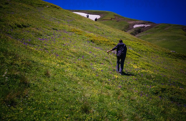 Hikers with backpacks and trekking poles walking in Turkish highland