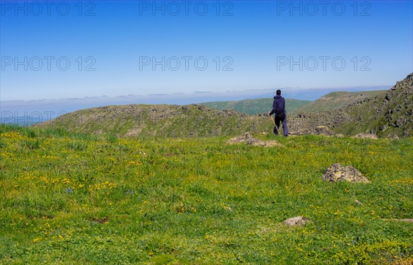 Hikers with backpacks and trekking poles walking in Turkish highland