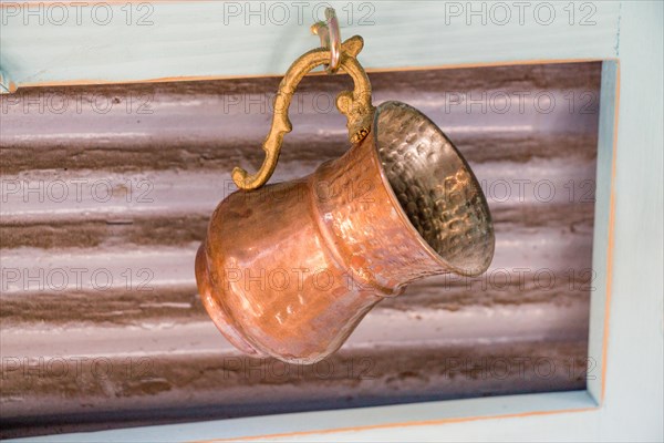 Ancient metal jug in oriental style in antique market