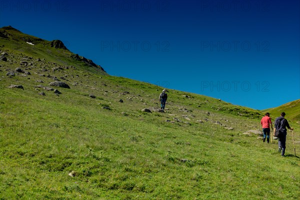 Hikers with backpacks and trekking poles walking in Turkish highland