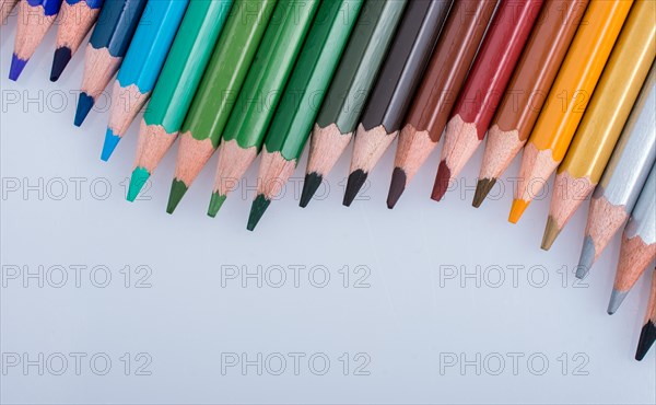 Color Pencils of Various colors placed on white background