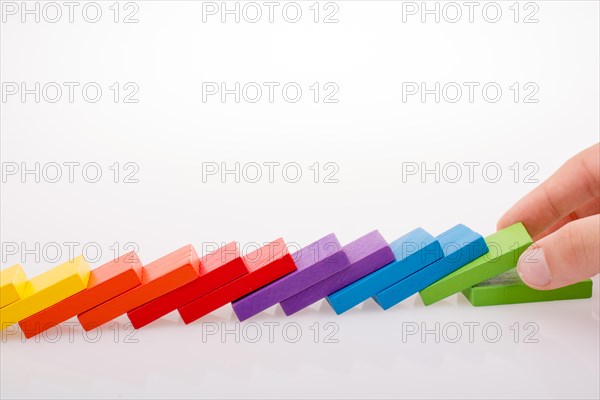 Hand holding color dominoes on a white background