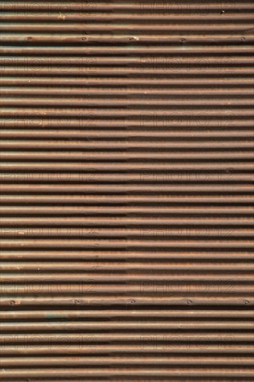 Straight lines on a shop front shutter as a metal background