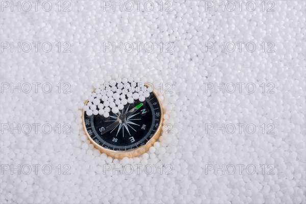 Compass on little white polystyrene foam balls