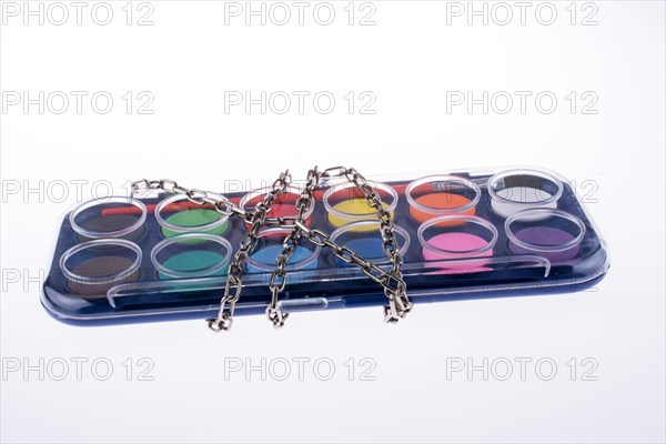 Watercolour paint set in chains on a white background