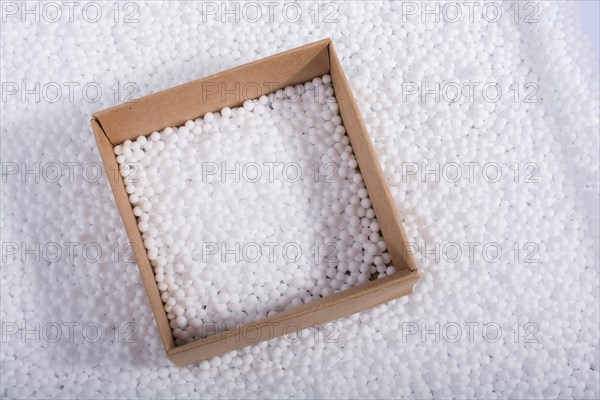 Box on little white polystyrene foam balls