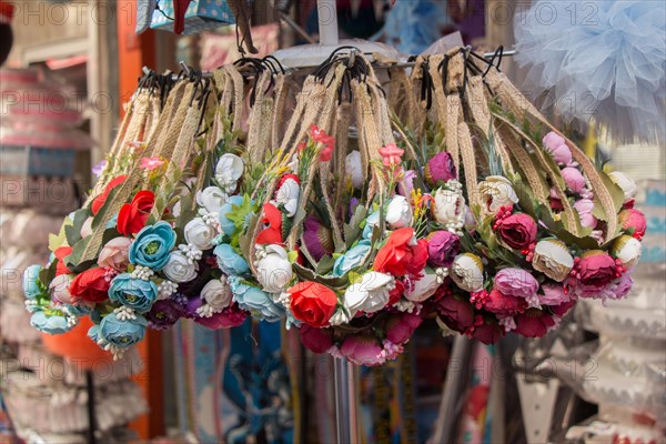 Colorful crowns for sale made of fake flowers