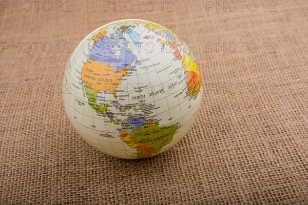 Globe placed on a brown fabric background