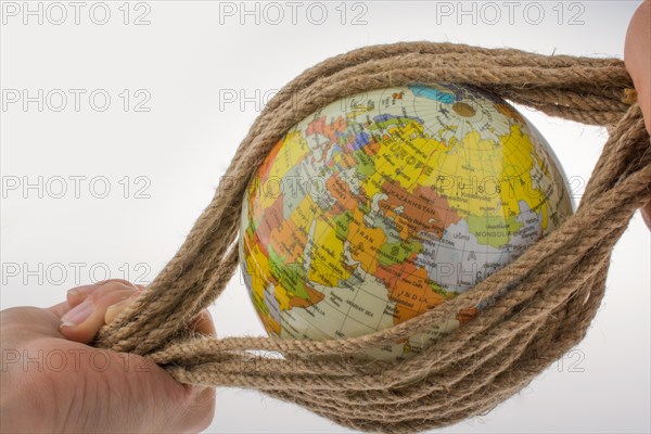 Hands holding the globe wrapped in rope