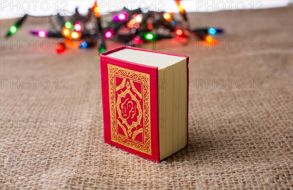 Islamic Holy Book Quran with lights behind