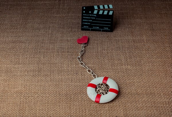 Heart attached to a life preserver and a cinema clapper