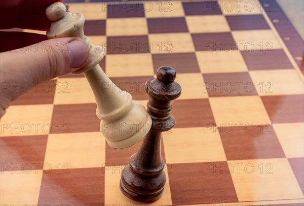 Person playing chess game making a move on board