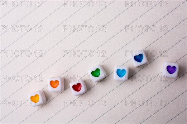 Colorful cubes with a heart placed on paper