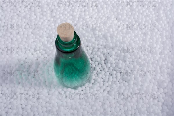 Empty bottle on little white polystyrene foam balls