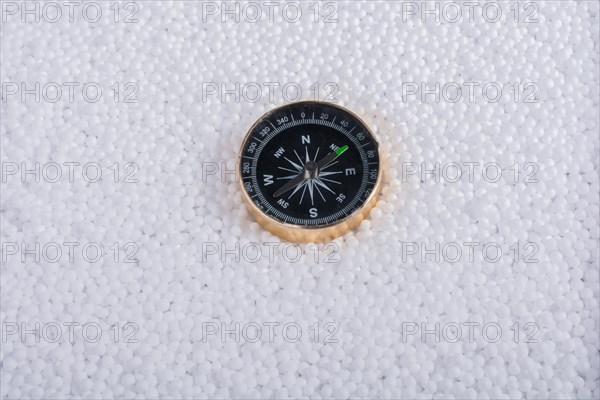 Compass on little white polystyrene foam balls