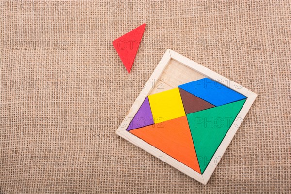 Colorful pieces of a square tangram puzzle