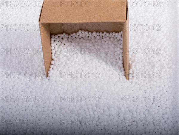 Box on little white polystyrene foam balls