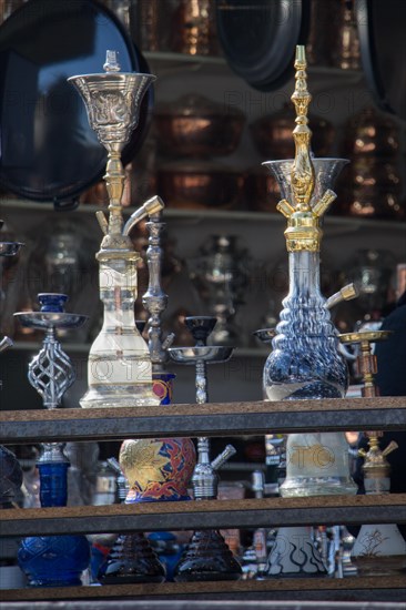 Group of eastern hookahs placed of various colors on a shelf