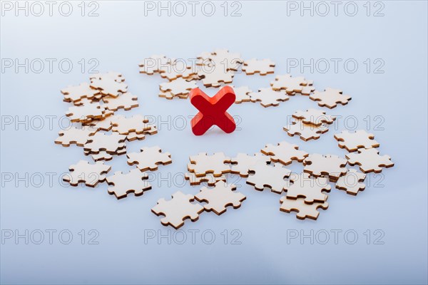 Pieces of jigsaw puzzle around x as problem solution business concept