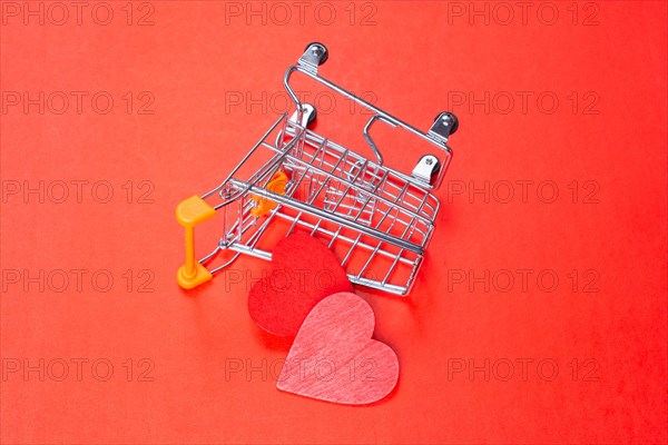 Red hearts and shopping cart. Valentines Day background. Greeting card for holiday