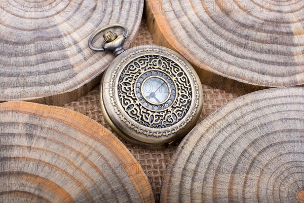 Mechanical pocket watch on pieces of wood