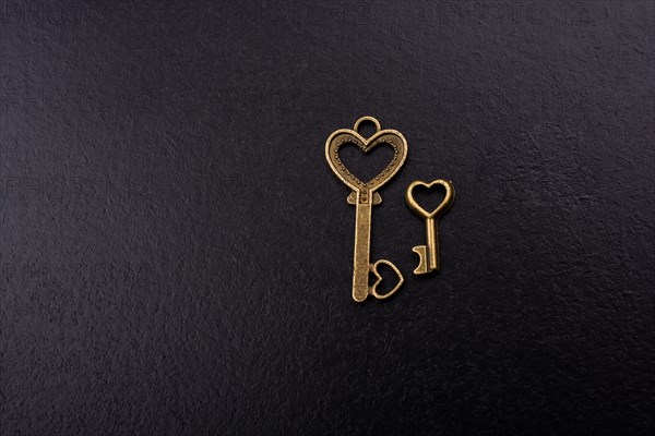 Heart shaped retro metal keys on dark background