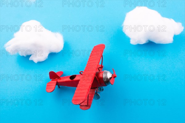 Retro styled little red model airplane in sky