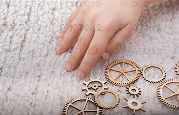 Hand holding gear wheels as the concept of mechanism