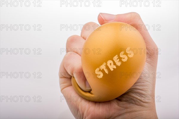 Squeezing yellow balloon with hand on a white background